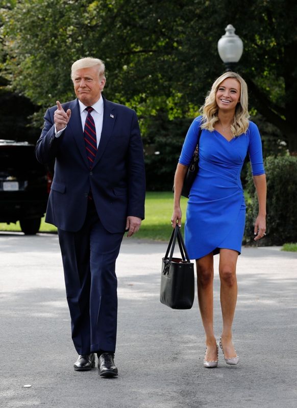 Kayleigh McEnany walking behind Donald Trump