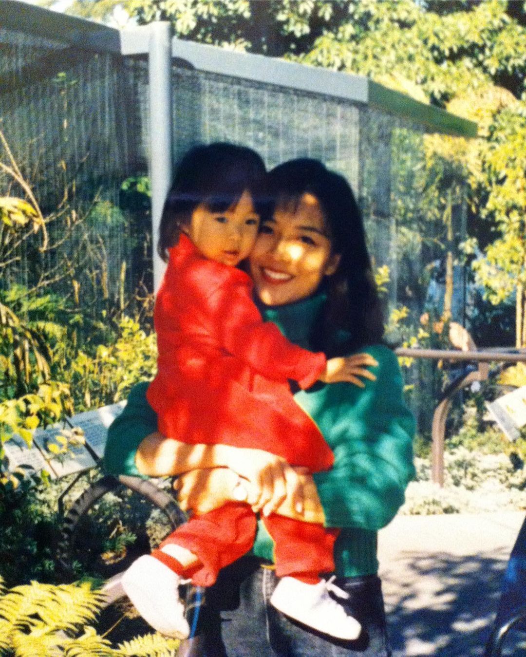 Childhood picture of Ashley Park with her mother