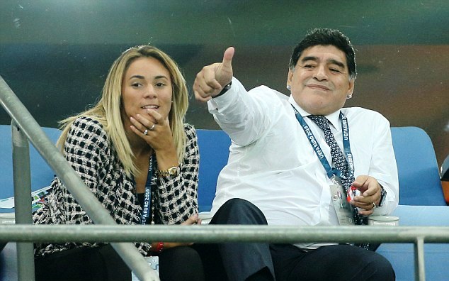 Diego and Oliva watching a football match at a stadium in 2014