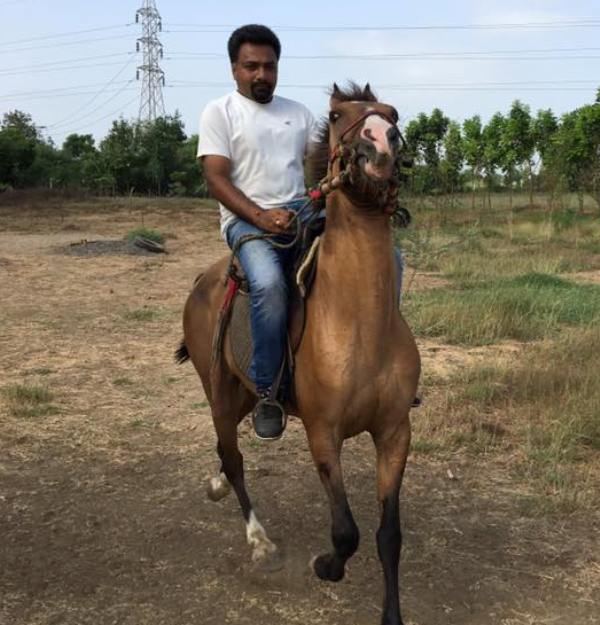 Hemant Kher riding a horse